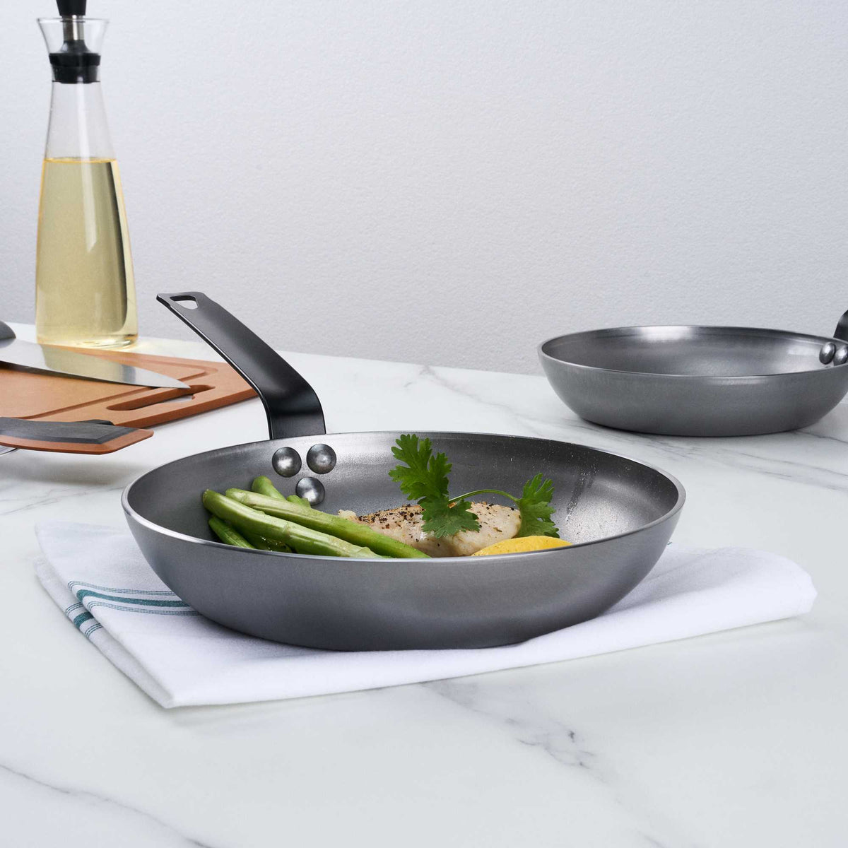 Met Lux 1 Carbon Steel 9 1/2" Non-Stick Fry Pan and 1 Black Silicone Pan Handle Sleeve